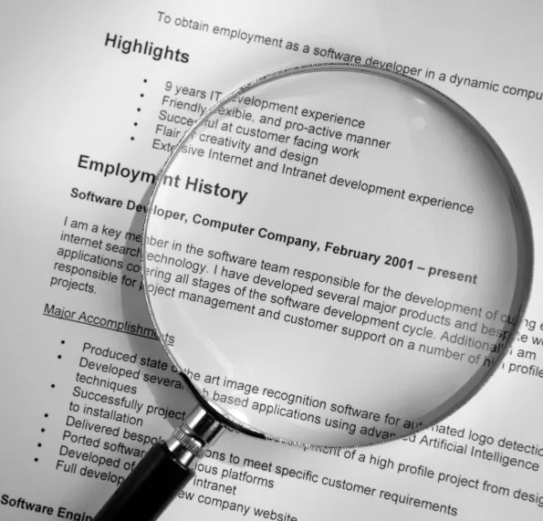 Magnifying glass over a software developer CV